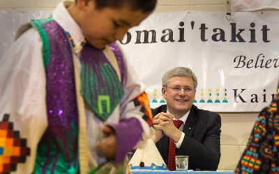 PM Stephen Harper watches some young dancers at Kainai