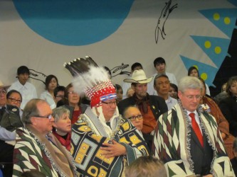 Prime Minister Stephen Harper (right), Blood Tribe Chief Charles Weaselhead (cen