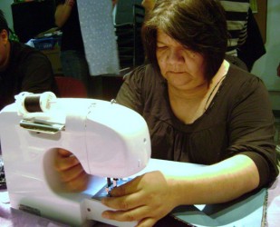 Donna Naughton at a workshop making a cradleboard for her four-month old grandda