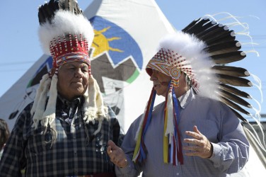 Piikani Elder Reg Crowshoe (left) bestowed the Blackfoot name of Wolf Charger on