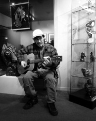 Itee Pootoogook plays guitar at a gallery