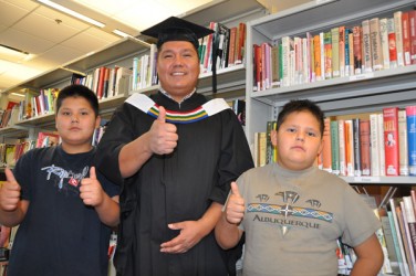 Vernon Watchmaker on graduation day with two of his seven children.