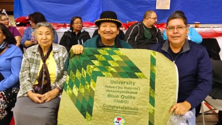 Holding Starblanket at the round dance celebration for Blue Wuills