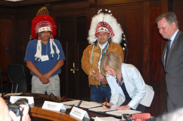 Premier Rachel Notley signs the protocol agreement Tuesday morning 