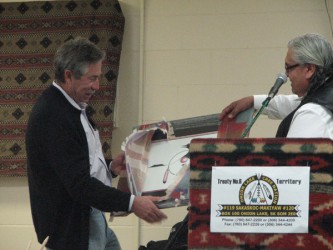 Chief Wallace Fox (right) of Onion Lake Cree Nation presents Bill Trickett, CEO 