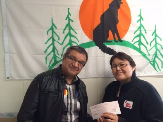 Chief Bruce Shisheesh (left) presents a cheque for $5,000 to Red Cross.