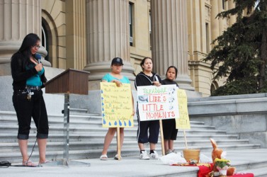 Sharon Gladue speaks from the steps of the Alberta Legislature 