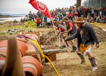 Carver Jaalen Edenshaw  dances in front of Legacy Pole before raising.