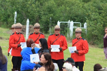 Four members of the Royal Canadian Mounted Police display the names of their fam