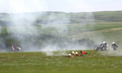 A smoky haze was visible on the battlefield with blasts from a cannon fired by a