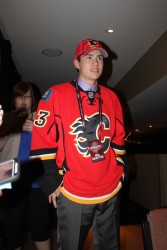 Eric Roy tries on his Calgary Flames’ jersey after being drafted by the NHL club