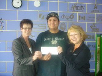 Christian Bear (center) accepts a $20,000 cheque from Linda Moulin(left) and Car