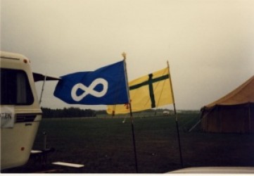 The Fransaskois and Métis flags fly on the grounds of the Fete Fransaskoise at B