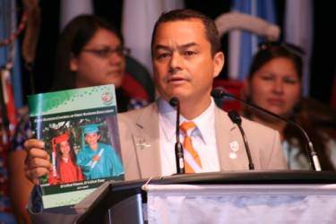 National Chief Shawn Atleo holding up a copy of the AFN’s education report: Firs