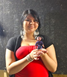 Raven Brass holds up a miniature figure of ‘Raven’ the character she dialogues f