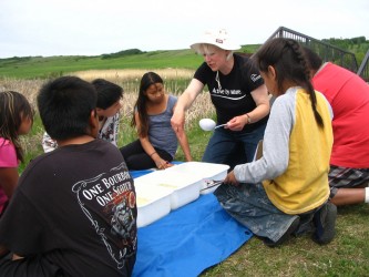 A lesson on aquatic life allows students to examine dragonfly larva, spidermites