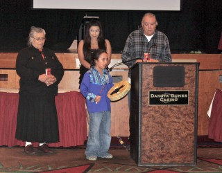 Blue Linklater sang with his drum to honor graduates, standing alongside his gra